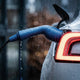 Wet EV charging cable connector on a car in a rainstorm showing weather protection